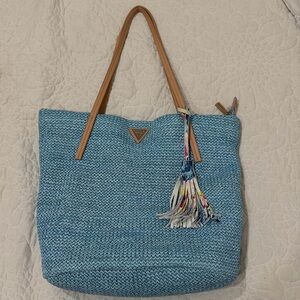 Guess Light Blue Woven Tote with Tan Handles and Multicolor Tassel